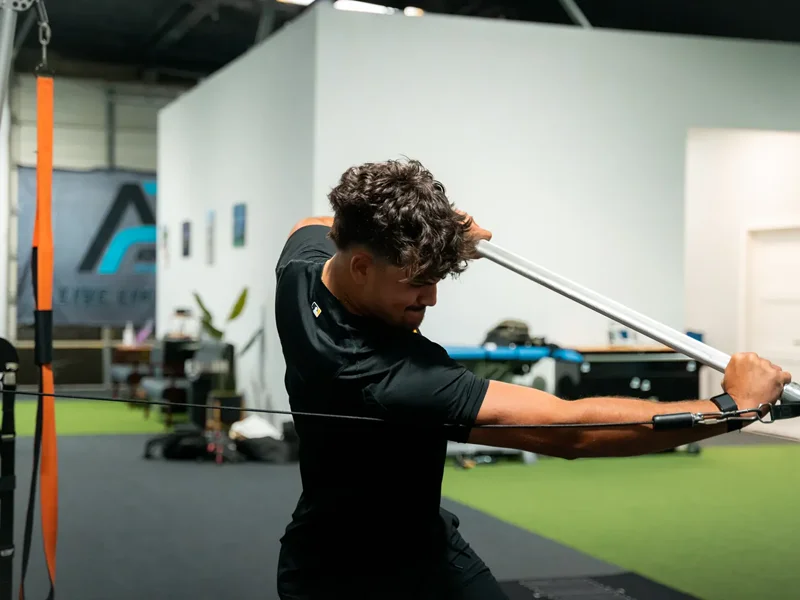 Close-up of an athlete's wrist and forearm under load while pulling a resistance bar