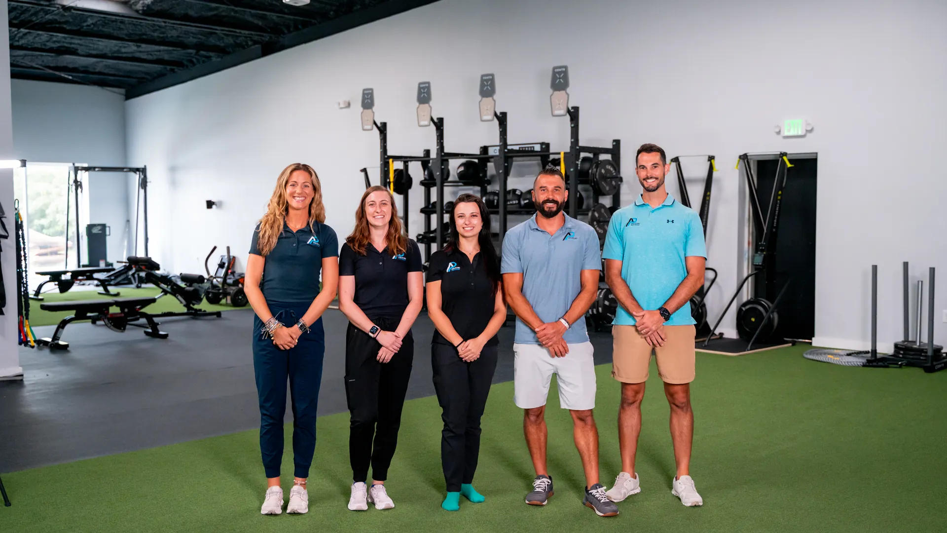 The Athlete Pro Sports Medicine team standing together in the clinic training area
